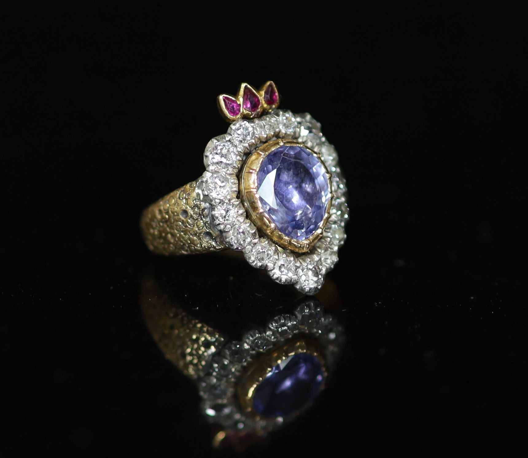 A 19th century gold, pear shaped sapphire, ruby and old cut diamond set flaming heart ring